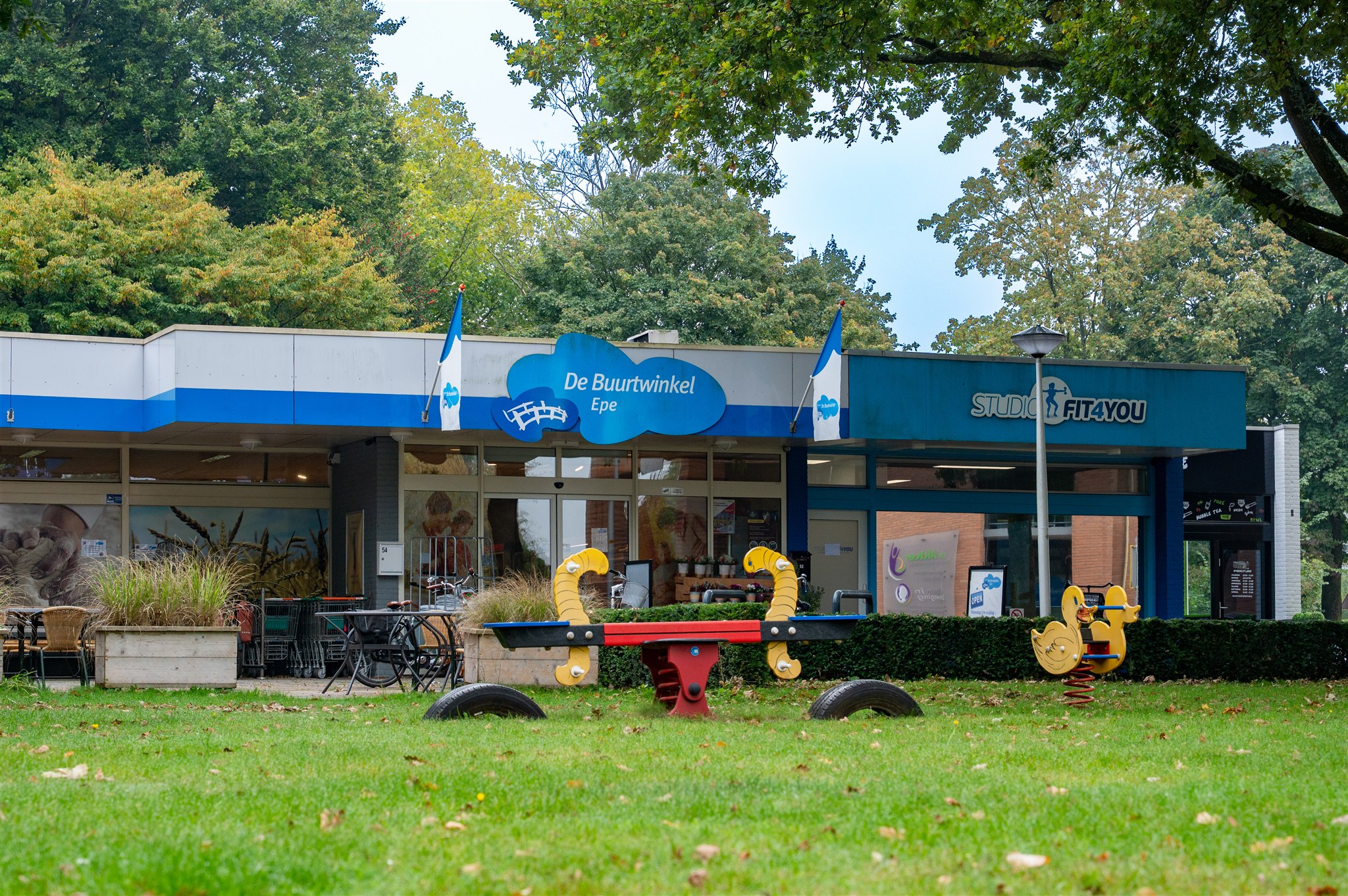 Facility image - shows building with outdoor playground equipment and garden features