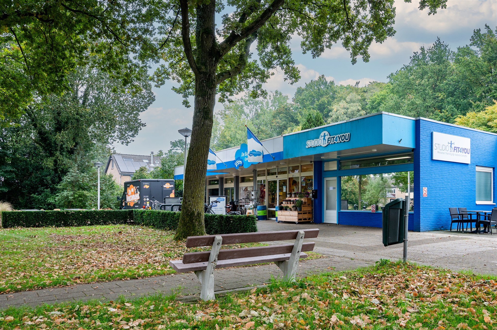 Facility image - side view showing full building structure in park setting